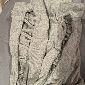 Grey leggings and a cross pattern at the ankle